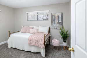 Carpeted bedroom with baseboards