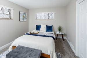 Bedroom featuring carpet, baseboards, and visible vents