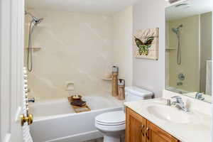 Full bathroom featuring vanity, toilet, and bathing tub / shower combination