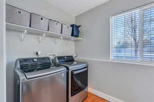 Laundry room with light tile patterned floors, laundry area, independent washer and dryer, and baseboards