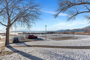View of property's community featuring a water and mountain view and uncovered parking