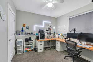Office with a textured ceiling, ceiling fan, and carpet floors