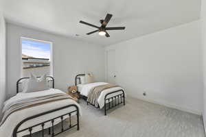 Bedroom with visible vents, light colored carpet, baseboards, and ceiling fan