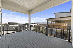 Wooden terrace featuring a residential view and a mountain view