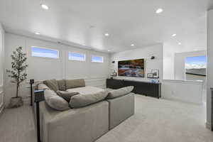 Living room featuring recessed lighting, baseboards, and light carpet
