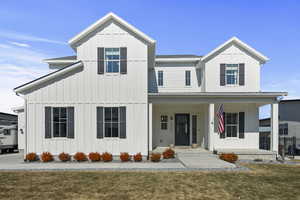 Modern farmhouse with a front yard and board and batten siding