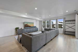 Lower Level Living area with recessed lighting and light wood finished floors.  walkout to rear yard area.