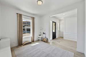 Foyer entrance featuring light wood finished floors, recessed lighting, and baseboards