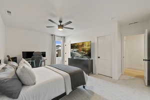 Bedroom featuring a ceiling fan, light colored carpet, visible vents, and baseboards