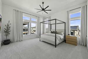 Bedroom featuring light carpet and a ceiling fan