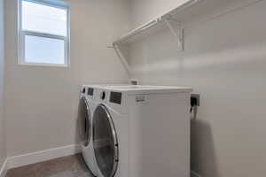 Laundry room featuring washer and dryer, baseboards, and laundry area
