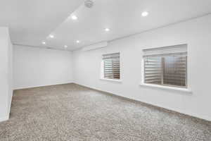 Spare room featuring recessed lighting, baseboards, carpet flooring, and a wall mounted AC
