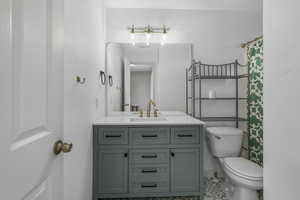 Full bathroom with toilet and vanity