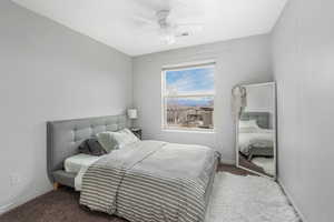 Bedroom with visible vents, baseboards, carpet floors, and ceiling fan