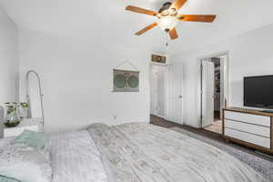 Bedroom featuring a ceiling fan and carpet