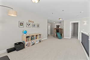Rec room featuring baseboards and carpet flooring