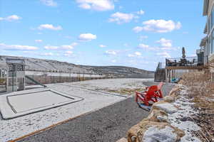 View of yard featuring a mountain view, stairs, and a playground