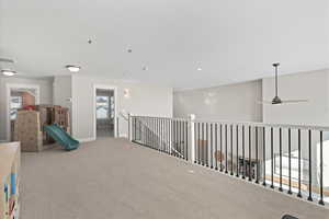 Playroom with baseboards, carpet, and ceiling fan