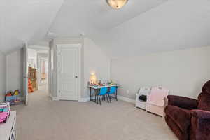 Recreation room featuring visible vents, baseboards, lofted ceiling, and carpet floors