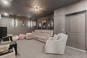 Carpeted living area featuring visible vents and a textured ceiling