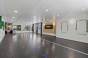 Workout area with recessed lighting, a textured ceiling, and baseboards