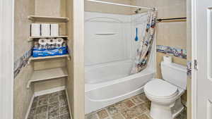 Full bathroom with toilet and shower / bath combo