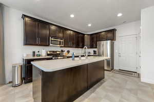 Kitchen with upgraded cabinetry, stainless steel appkliances and finishes, and large countertop island