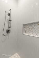 Room details featuring tiled shower