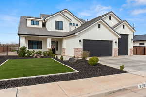 Modern farmhouse style home with board and batten siding, a front lawn, fence, concrete driveway, and an attached garage