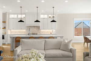 Living area featuring recessed lighting, baseboards, and light wood finished floors