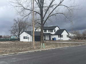 View of front facade with roof with shingles