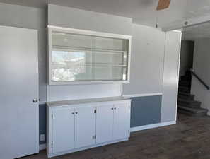 Kitchen with white cabinetry, light countertops, and ceiling fan