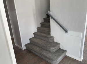 Stairs featuring wood finished floors