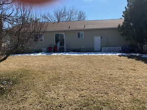 Rear view of house with a lawn