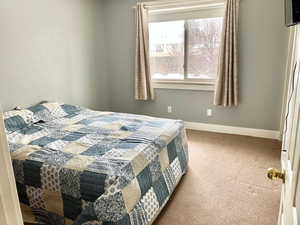 Carpeted bedroom with baseboards