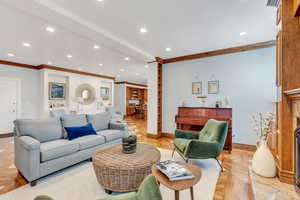 Living room featuring crown molding, recessed lighting, and baseboards
