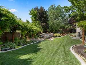 View of yard featuring fence