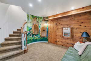 Living room featuring stairs, a textured ceiling, recessed lighting, and carpet flooring