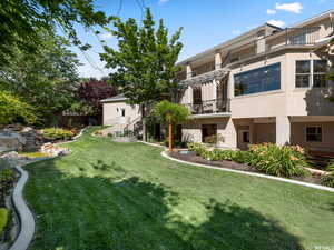 View of yard featuring a balcony
