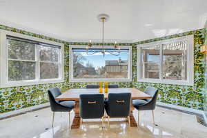 Dining room with plenty of natural light and a notable chandelier