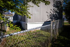 View of home's exterior with fence and a mountain view