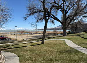Surrounding community featuring a yard and a water and mountain view