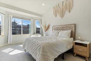 Carpeted bedroom featuring visible vents, recessed lighting, baseboards, and lofted ceiling