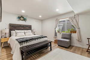 Bedroom featuring visible vents, recessed lighting, wood finished floors, and baseboards