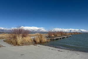 Dock area with a water and mountain view