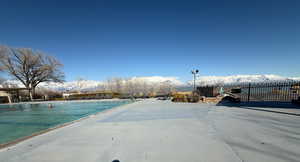 View of swimming pool featuring a mountain view and fence