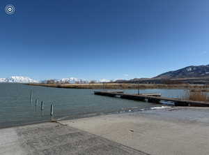 View of dock featuring a water and mountain view