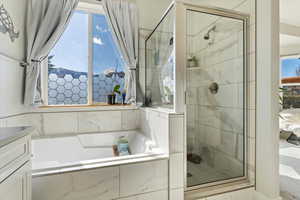 Full bath with a garden tub and a stall shower