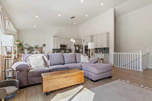 Living room featuring recessed lighting, light wood finished floors, and high vaulted ceiling