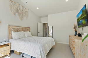 Bedroom with light carpet, recessed lighting, and baseboards